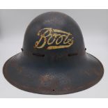 A WW2 British Home Front Boots the Chemist Fire Watcher’s Helmet.