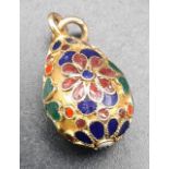 An 18 k yellow gold and enamel egg charm. Weight: 3.8 g.