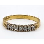 An 18K Yellow Gold Seven-Diamond Ladies Ring. Seven brilliant round cut diamonds. Size M 1/2. 2.2g