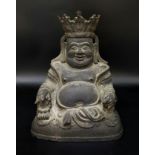 A MING DYNASTY FIGURE OF A BUDAI IN BRONZE (1368-1644) A JOVIAL BRONZE CROWNED FIGURE SEATED IN
