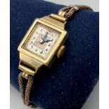 A Vintage 9K Gold Cased Ladies Watch. Rolled gold strap with a 9K gold case. In need of repair so as