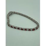 SILVER TENNIS BRACELET Set with red and clear quartz gemstones.19 cm.