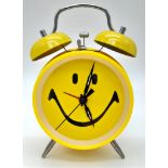 A VINTAGE YELLOW SMILEY FACE DOUBLE BELL ALARM CLOCK. HEIGHT18CM. IN WORKING ORDER.