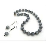 A hypnotic, grey chrysoberyl cat’s eye, large beaded (14 mm), necklace and earrings set exhibiting