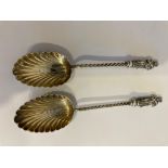2 x ANTIQUE SILVER APOSTLE COFFEE SPOONS, having silver twist handles with shell bowls and clear