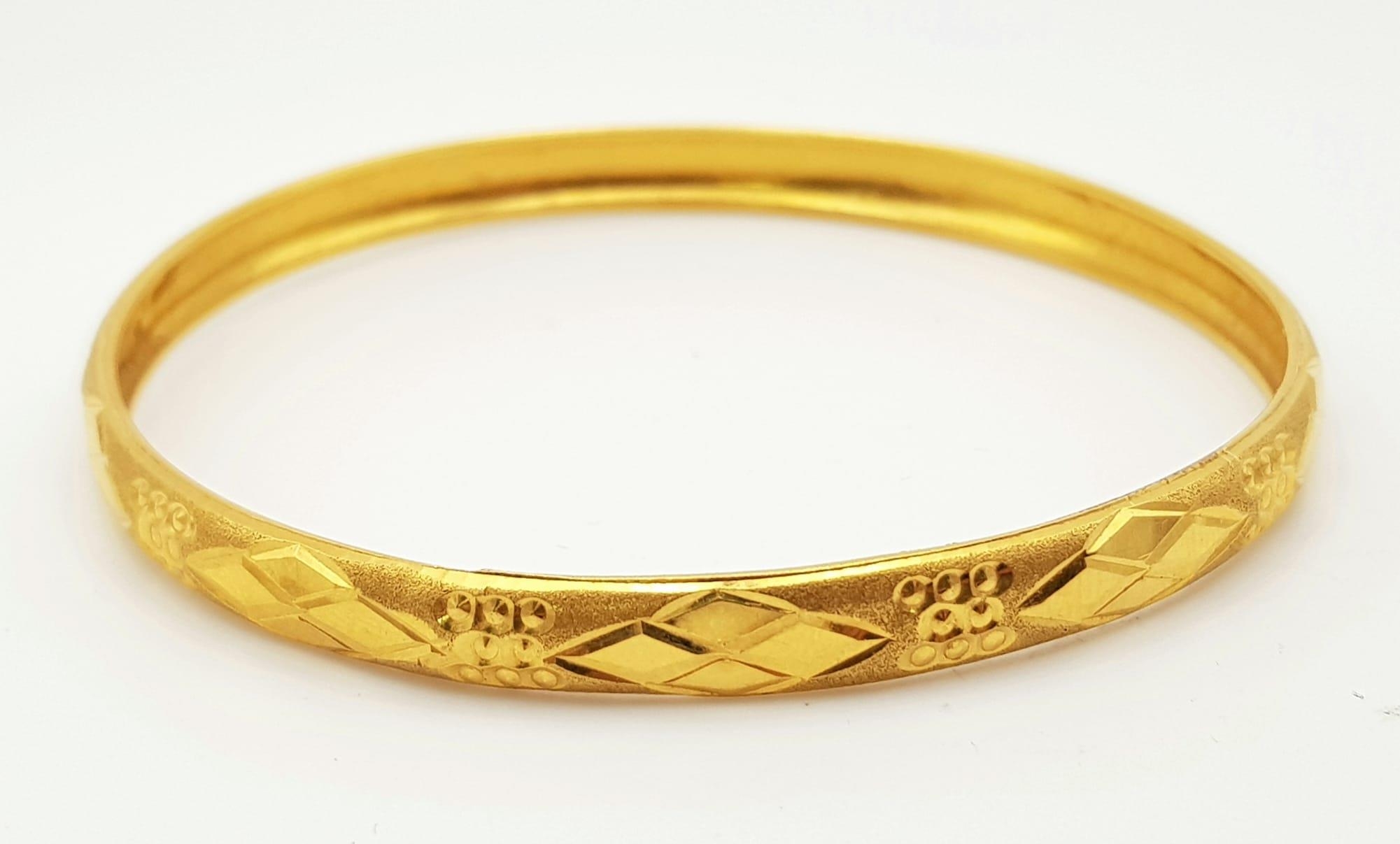 A 22K Yellow Gold Bangle. 65mm inner diameter. 9.58g. Ref: 3876.