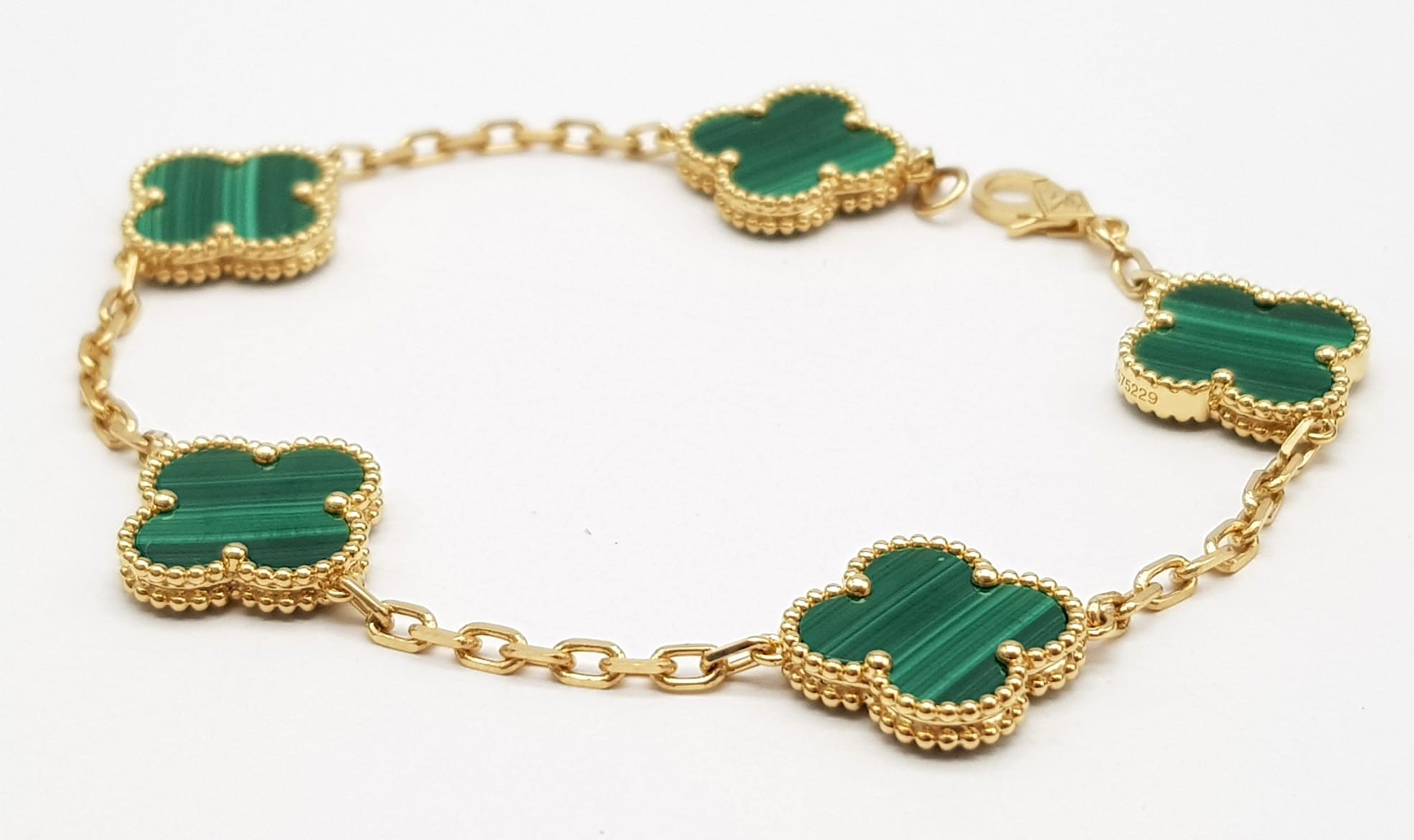 A Van Cleef and Arpels Alhambra bracelet with 5 motifs - 18ct yellow gold with malachite inserts.