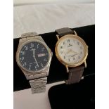 2 vintage wristwatches . Firstly a Gentlemans LORUS Quartz DAY/DATE wristwatch in Silver tone with