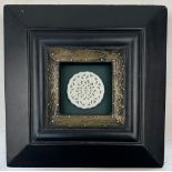 An exquisitely carved, antique, Chinese, white jade amulet, mounted on a wooden frame with