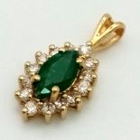 An 18K Emerald and Diamond Pendant. Oval emerald with a diamond surround. 20mm. 1.3g total weight.