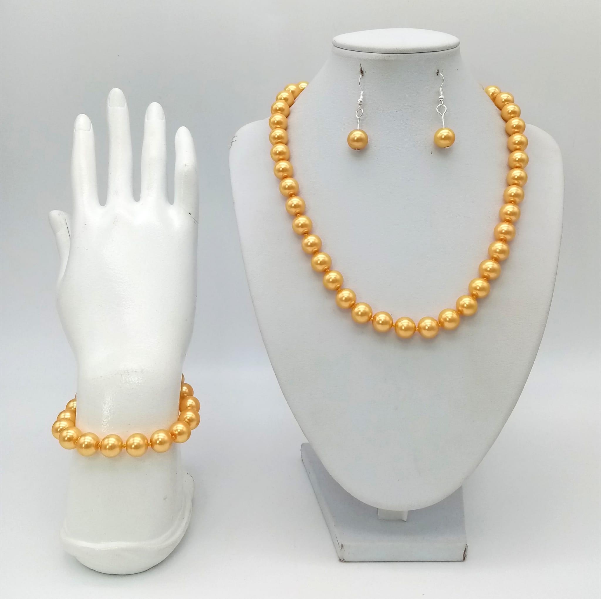 A South Sea Pearl Shell Golden Necklace, Bracelet and Earring Set. 42cm. 16cm. 3cm drop.