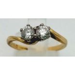 A Vintage 18K Yellow Gold Two Diamond Gemstone Crossover Ring. Two brilliant round cut diamonds -