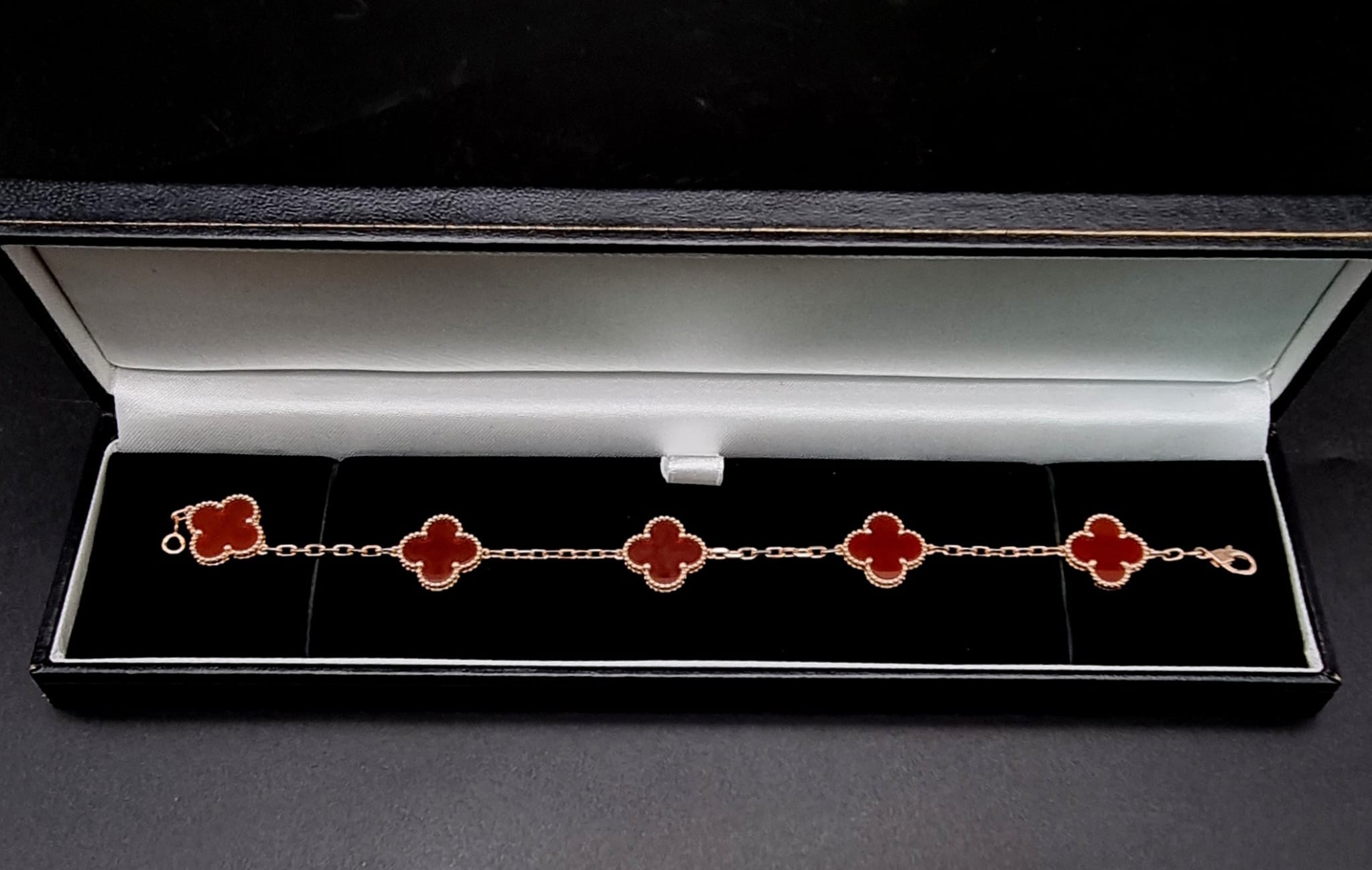 A Van Cleef and Arpels Alhambra bracelet with 5 motifs - 18ct rose gold with cornelian inserts. - Image 6 of 6