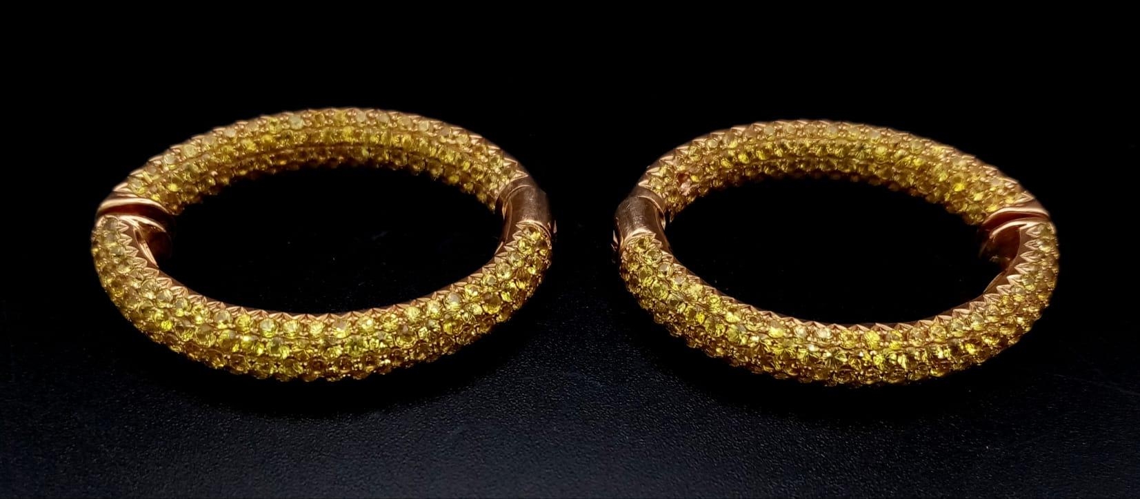 An 18K Yellow Gold and Yellow Stone Pair of Hoop Earrings. 19.16g total weight. Ref: 3710.