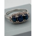 SILVER RING having A trilogy of polished BLUE SPINEL cabochon set to top with WHITE TOPAZ