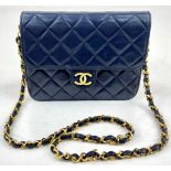 A Vintage Chanel Mini Flap Handbag. Blue quilted lambskin. Gold-tone hardware with CC lock. Interior