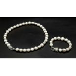 A very elegant, natural, cultured, white pearl and cubic zirconia necklace and bracelet set with