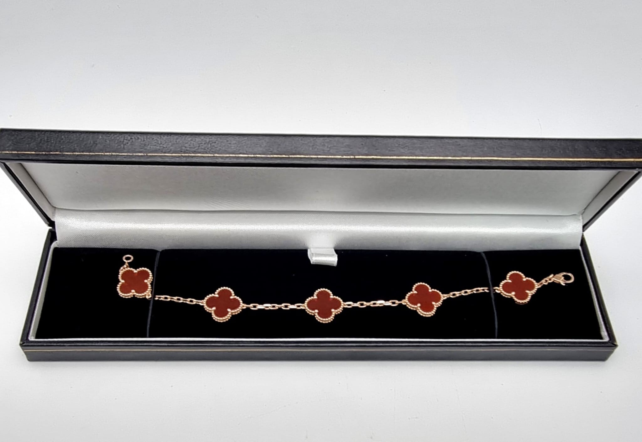 A Van Cleef and Arpels Alhambra bracelet with 5 motifs - 18ct rose gold with cornelian inserts.