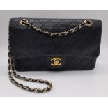 A Vintage Blue Chanel Flap Bag. Blue checked lambskin with a gilded CC clasp. Red leather interior