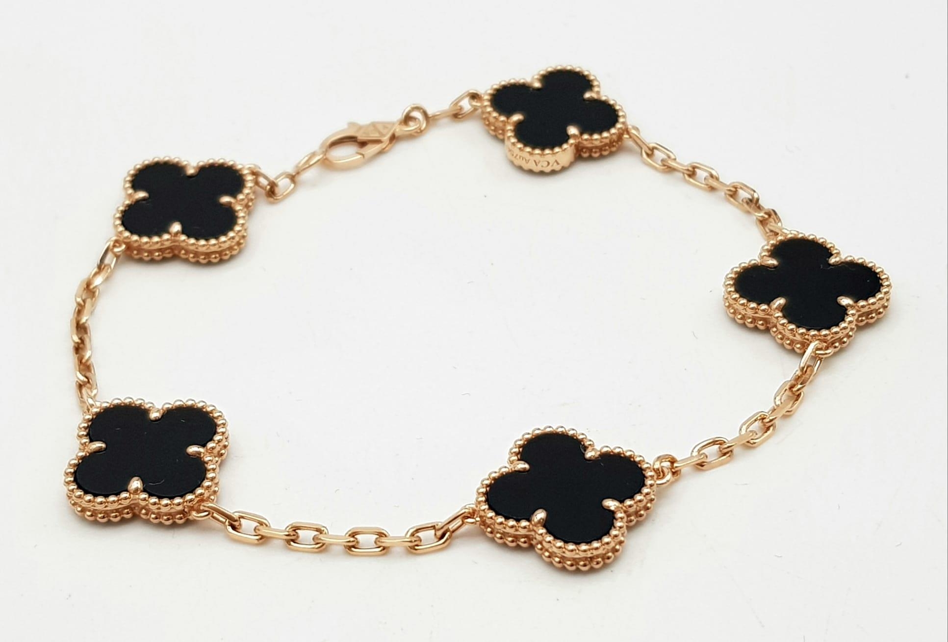 A Van Cleef and Arpels Alhambra bracelet with 5 motifs - 18ct rose gold with black onyx inserts.