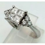 An 18 K white gold ring, with quality diamonds (1.05 carats) on central cluster and shoulders.