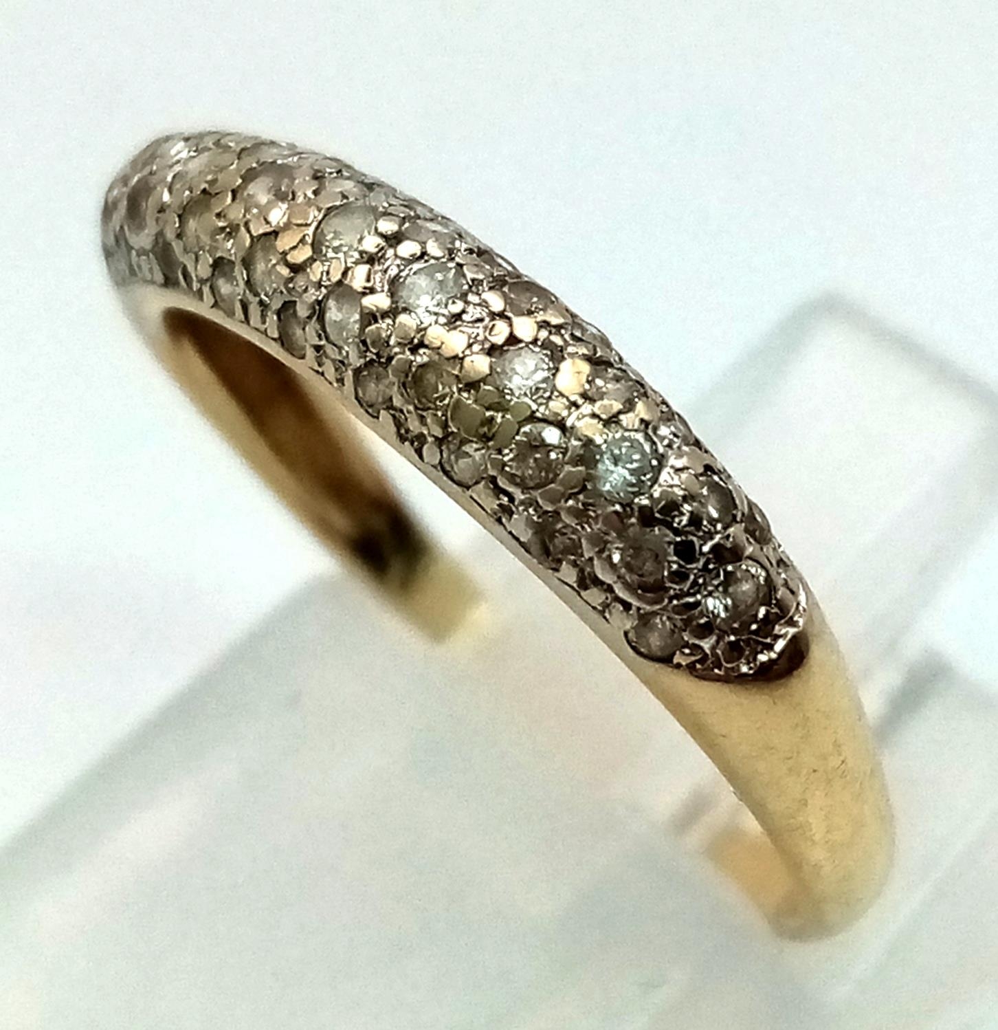 A 9k yellow gold diamond band ring. 0.30ct, 1.8g, size M.