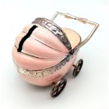 A vintage, baby pram moneybox with over hundred halfpenny coins (various dates) inside. These