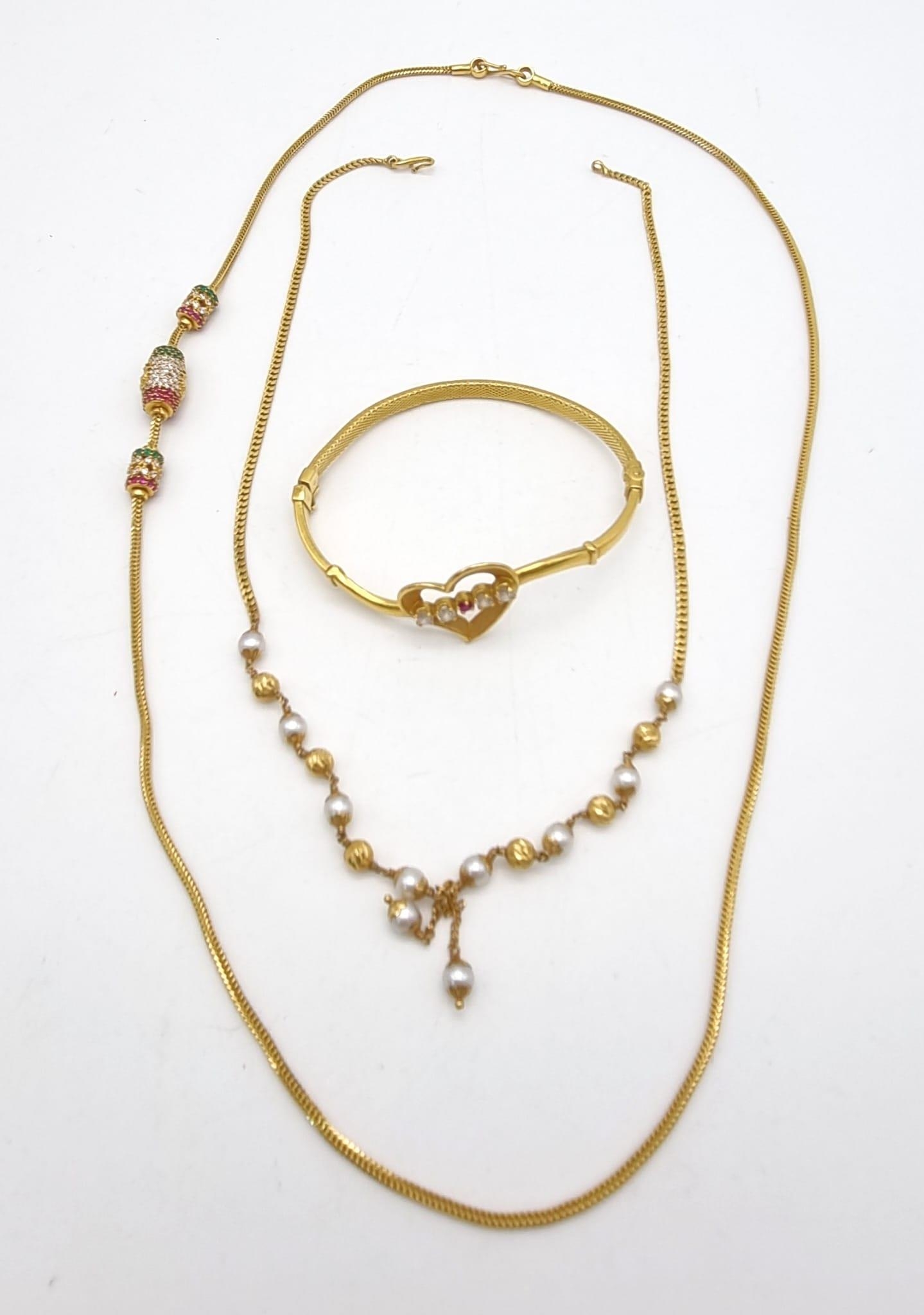 A 22K Gold Bangle and Two 18K Gold Necklaces. Both necklaces with stone decoration and small kinks