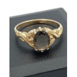 Ladies 9 carat GOLD and SMOKY QUARTZ RING, having an oval 0.75 carat smoky quartz gemstone mounted