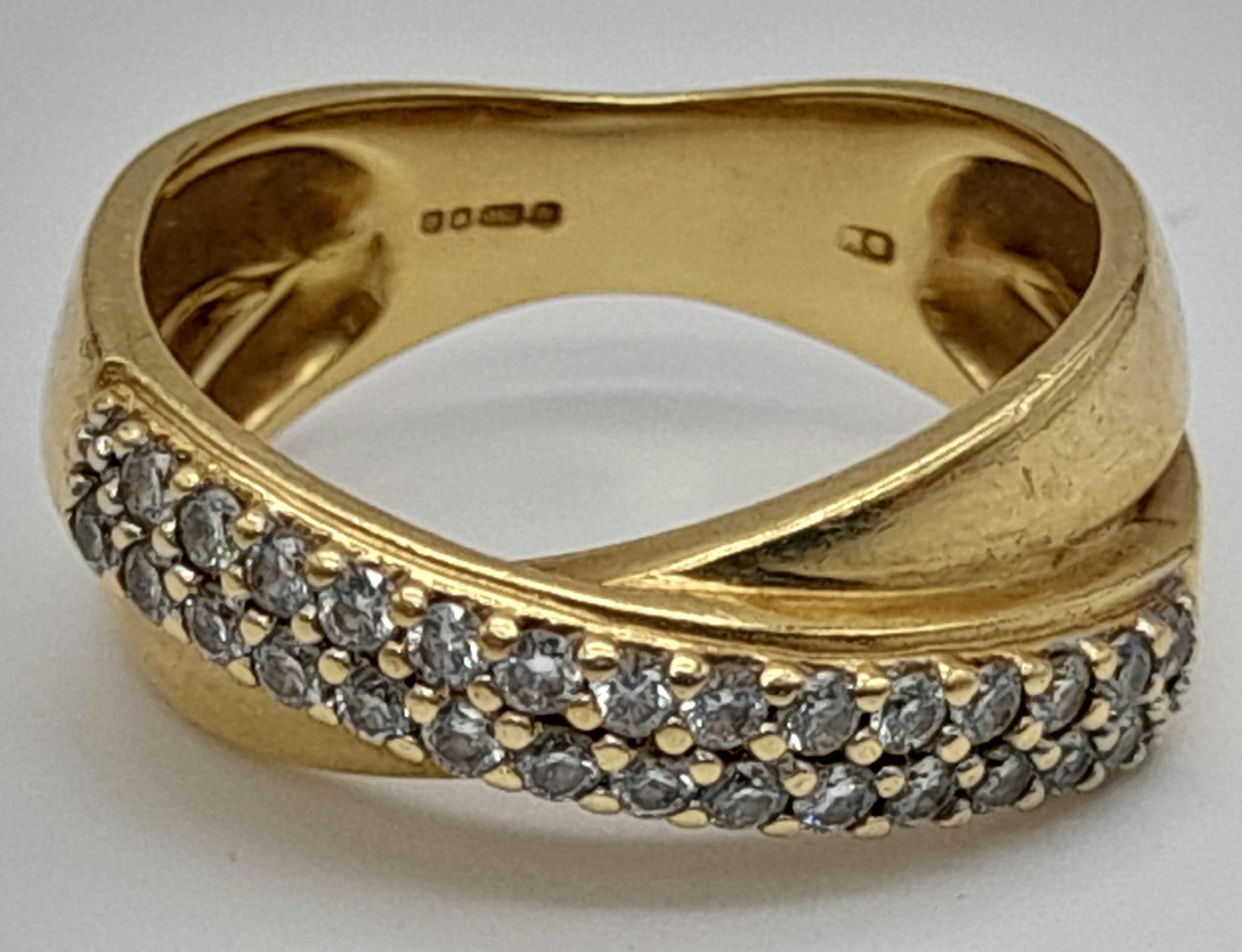 18k yellow gold twist cross over diamond ring. 0.50ct, 6.4g, size M.