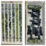 A vintage collection of six pairs of green jade chopsticks with animal shaped rests. In original,