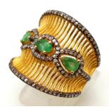 A very unusual, gold and silver ring with 3 Colombian emeralds and over 150 diamonds (tested) on