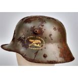 WW1 Imperial German M16 Stahlhelm with Machine Gunners Insignia and Battle Damage.