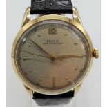 A 14K GOLD DOXA VINTAGE WRIST WATCH 1950/60'S MODEL MANUAL MOVEMENT ON A BLACK LEATHER STRAP. 35mm