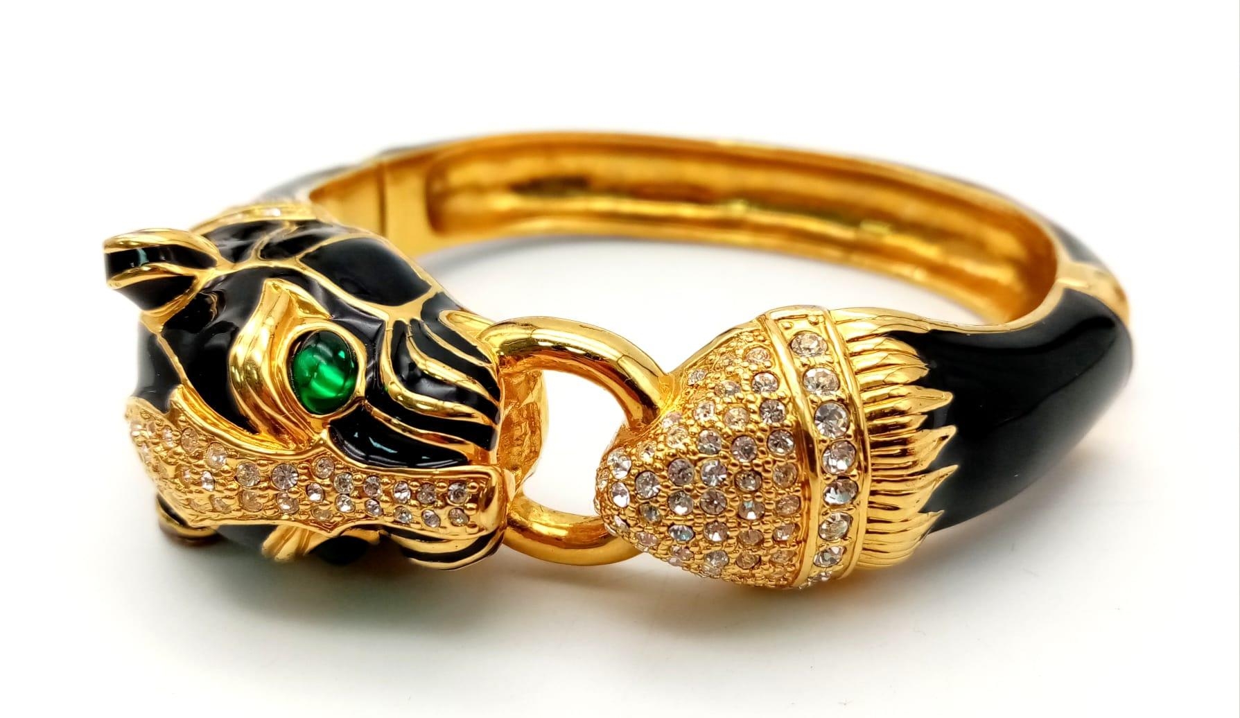 A fabulous black panther, enamel and gold filled bangle with cubic zirconia and synthetic emerald