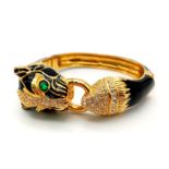 A fabulous black panther, enamel and gold filled bangle with cubic zirconia and synthetic emerald