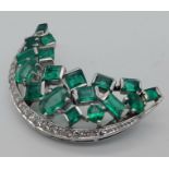 An 18K White Gold Emerald and Diamond Crescent Moon Brooch. Beautiful paved set emeralds - 4ct