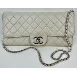 A Chanel Quilted Caviar Leather Flap Bag. Cream/Grey exterior with silver tone hardware. Chanel logo