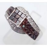 A 10K White Gold and Cognac Diamond Crossover Ring. Nine square-cut central cognac-coloured diamonds