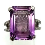 A 14.35ct Natural Amethyst Ring set in 925 silver, decorated with 0.50cts Diamonds on the wings.