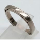 An 18K White Gold Modern Eternity Ring. A Circle in a square adjoined by eight small round cut