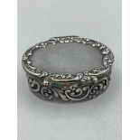 Vintage SILVER PILL BOX in oval form having scroll decoration to sides and lid.Attractive gilded