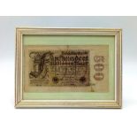 A FRAMED 500 MILLIOM MARKS NOTE ISSUED BY THE REICHBANK IN 1923.