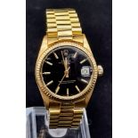 An 18K Solid Gold Rolex Perpetual Datejust Ladies Watch. Gold strap and case - 31mm. Black dial.