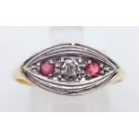 A vintage 18K yellow gold and platinum ring with a single diamond and two rubies. Ring size: R,