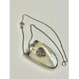 Antique silver and Mother of Pearl snuff bottle on a chain.