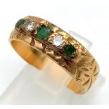 A Vintage 18K Yellow Gold Emerald and Diamond Five Stone Ring. Decorative band with three emeralds