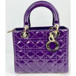 A Christian Dior - Lady Dior Purple Patent Leather Handbag. Gold tone hardware. Detachable