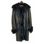 A sophisticated and fashionable YVES SAINT LAURENT real fur lined, knee length, leather coat,