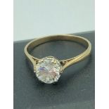 9 carat GOLD SOLITAIRE RING having large round cut 1.0 carat clear gemstone mounted to top. Full